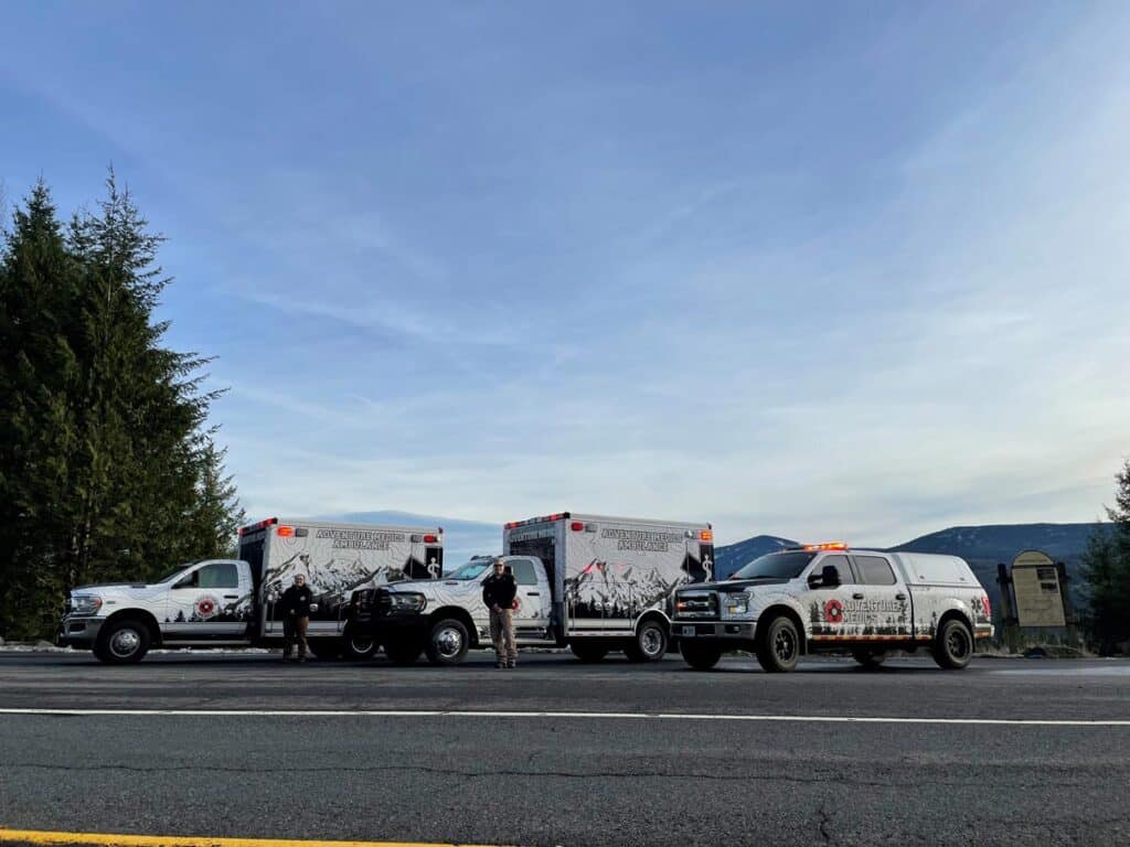 vehicles parked on side of road with two medics standing outside