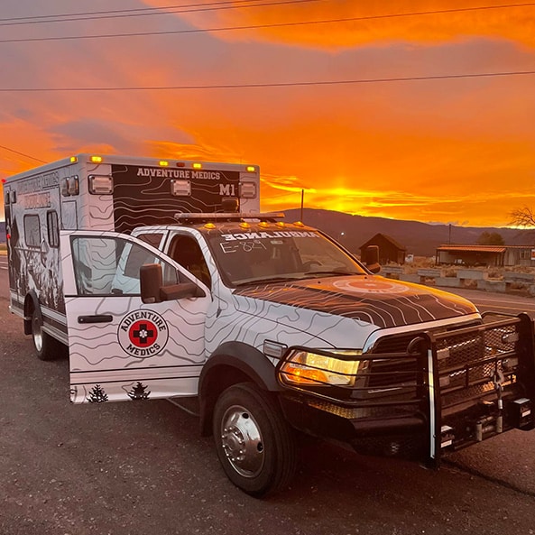 ambulance truck parked on side of road at sunset