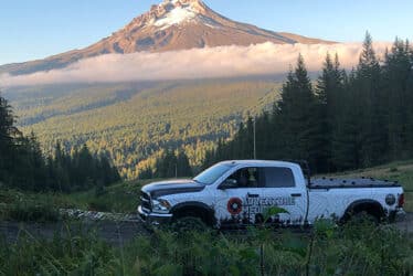 medic truck on dirt road overlooking mountain peak