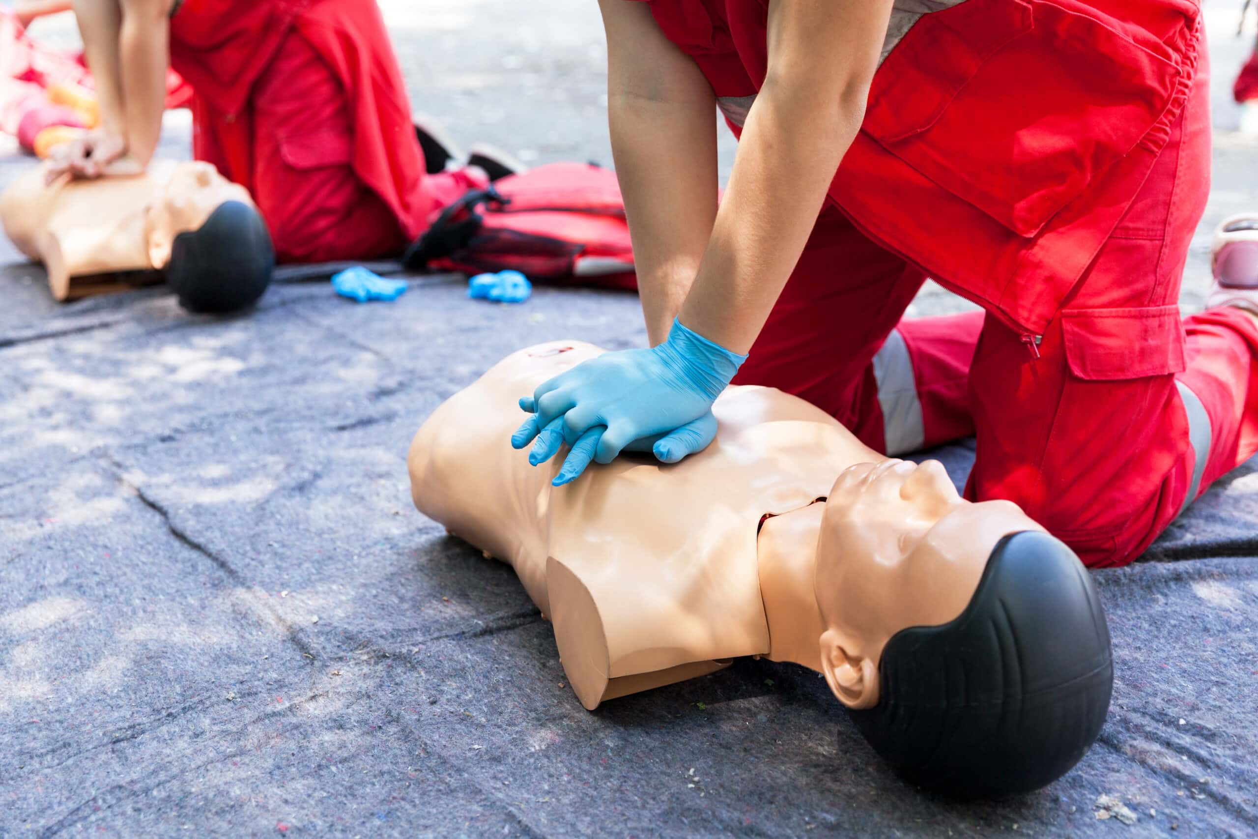 CPR training on a manikin with chest compressions during a CPR and First Aid class