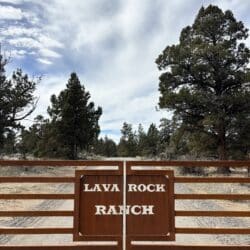 rustic gate with the words 'lava rock ranch' cut out