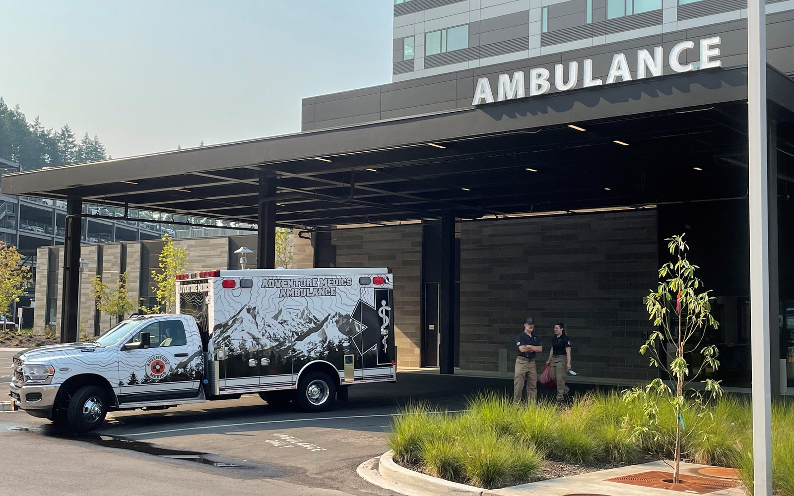Adventure Medics Type I critical care ambulance and transport crew at a hospital ambulance bay for an interfacility transfer